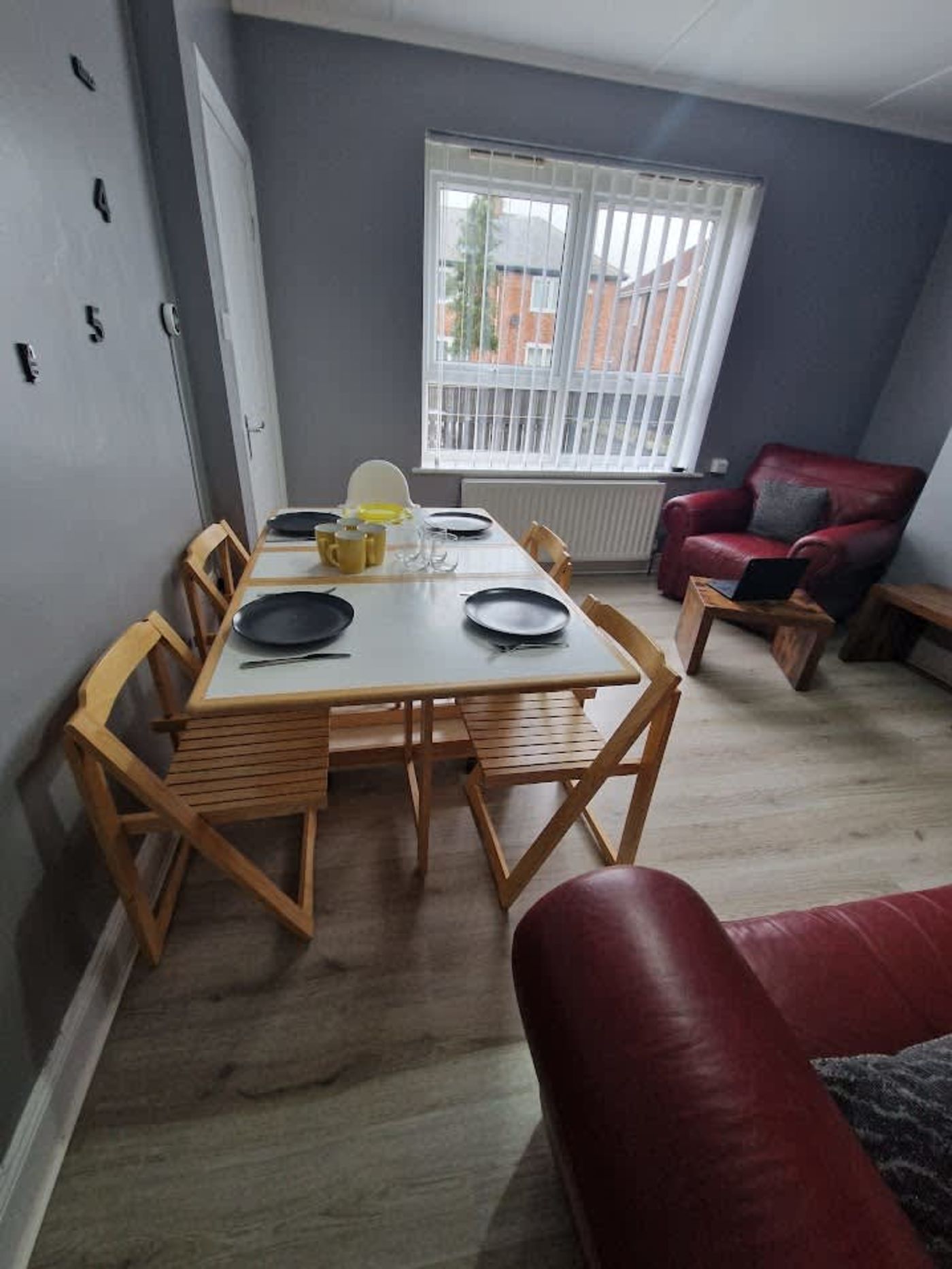 The living room with the folding table set for 4